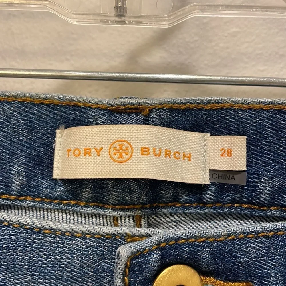 Tory Burch Connor jeans in medium allover stone wash. Cropped. Raffia fringed